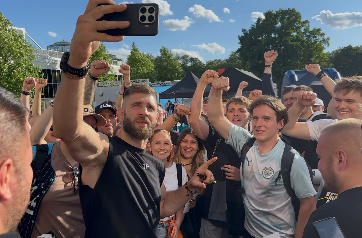 Jiri Prochazka taking a group selfie with fans at an outdoor event