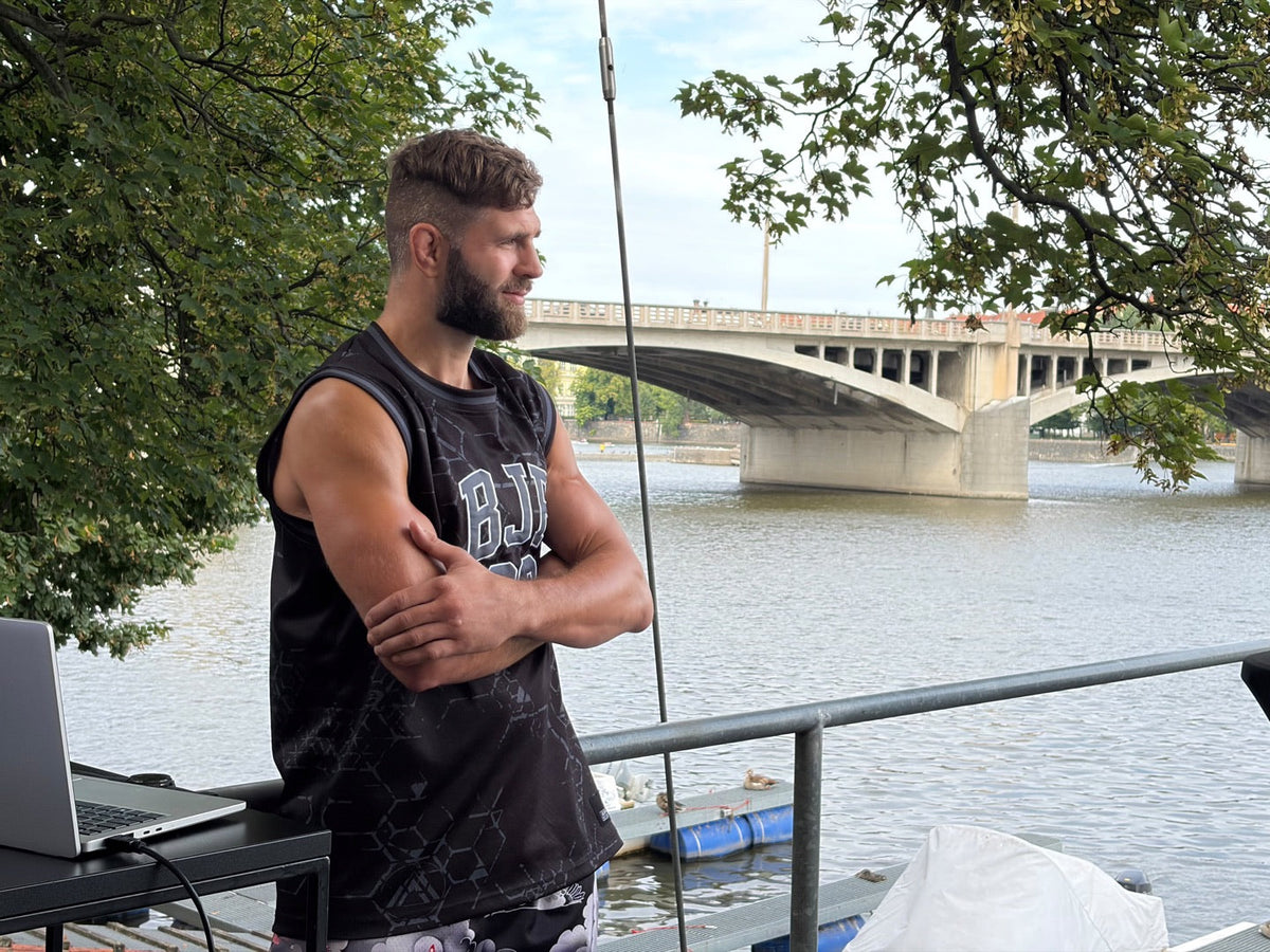 Jiri Prochazka wearing a BJP T-shirt by a river